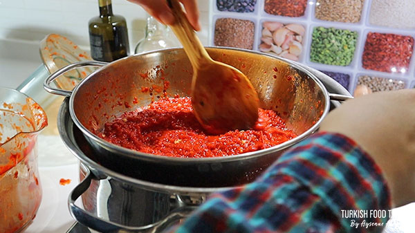 Straining the pureed peppers